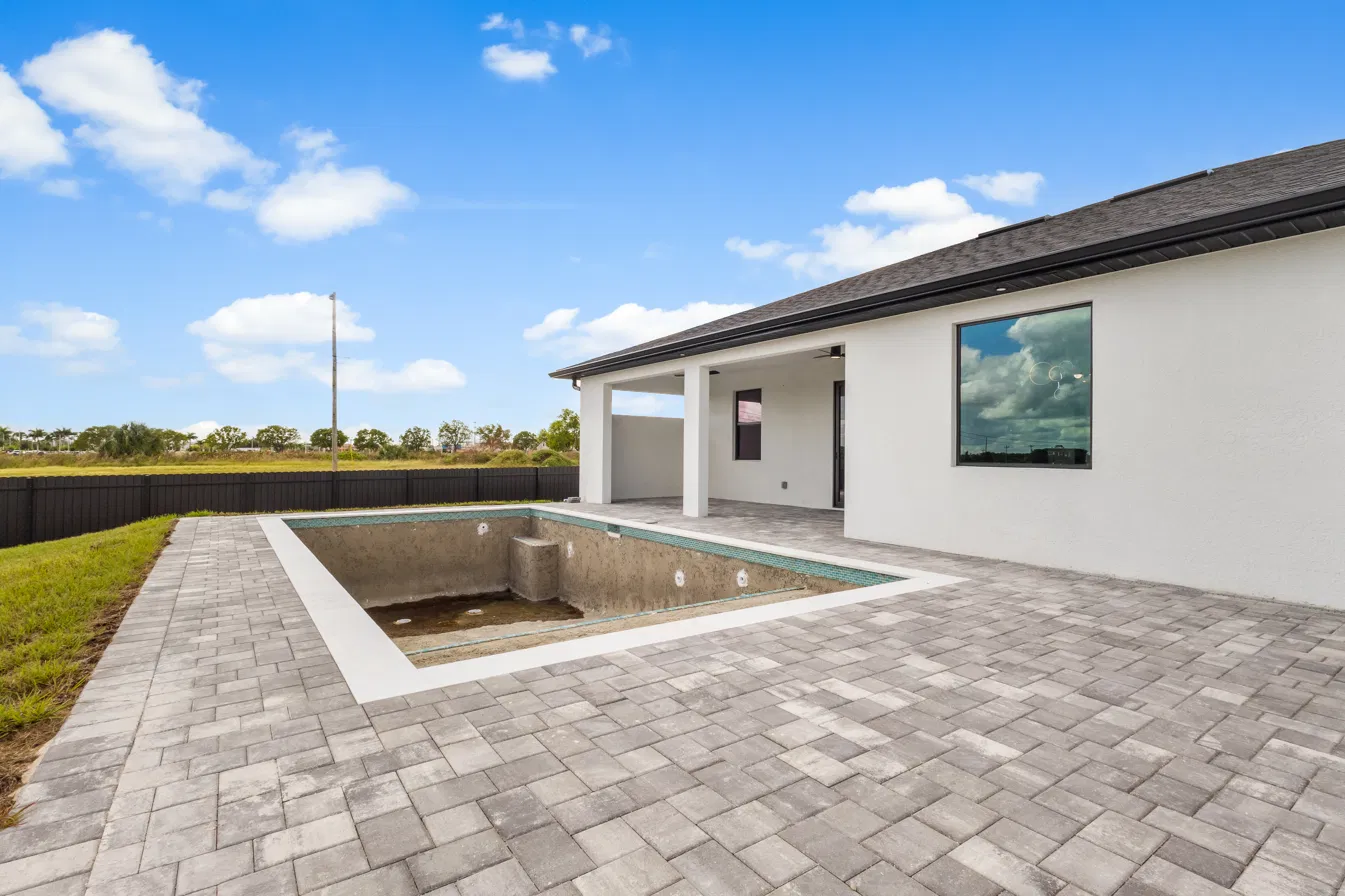 New backyard with an empty, unfinished pool before virtual pool enhancement