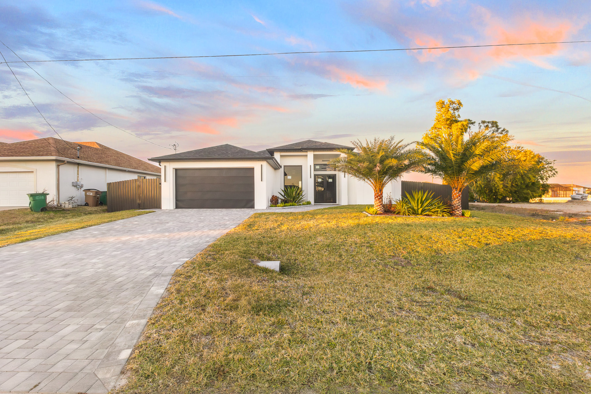 Home exterior under a colorful sunset sky